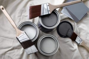 shades of grey paint in tins with brushes